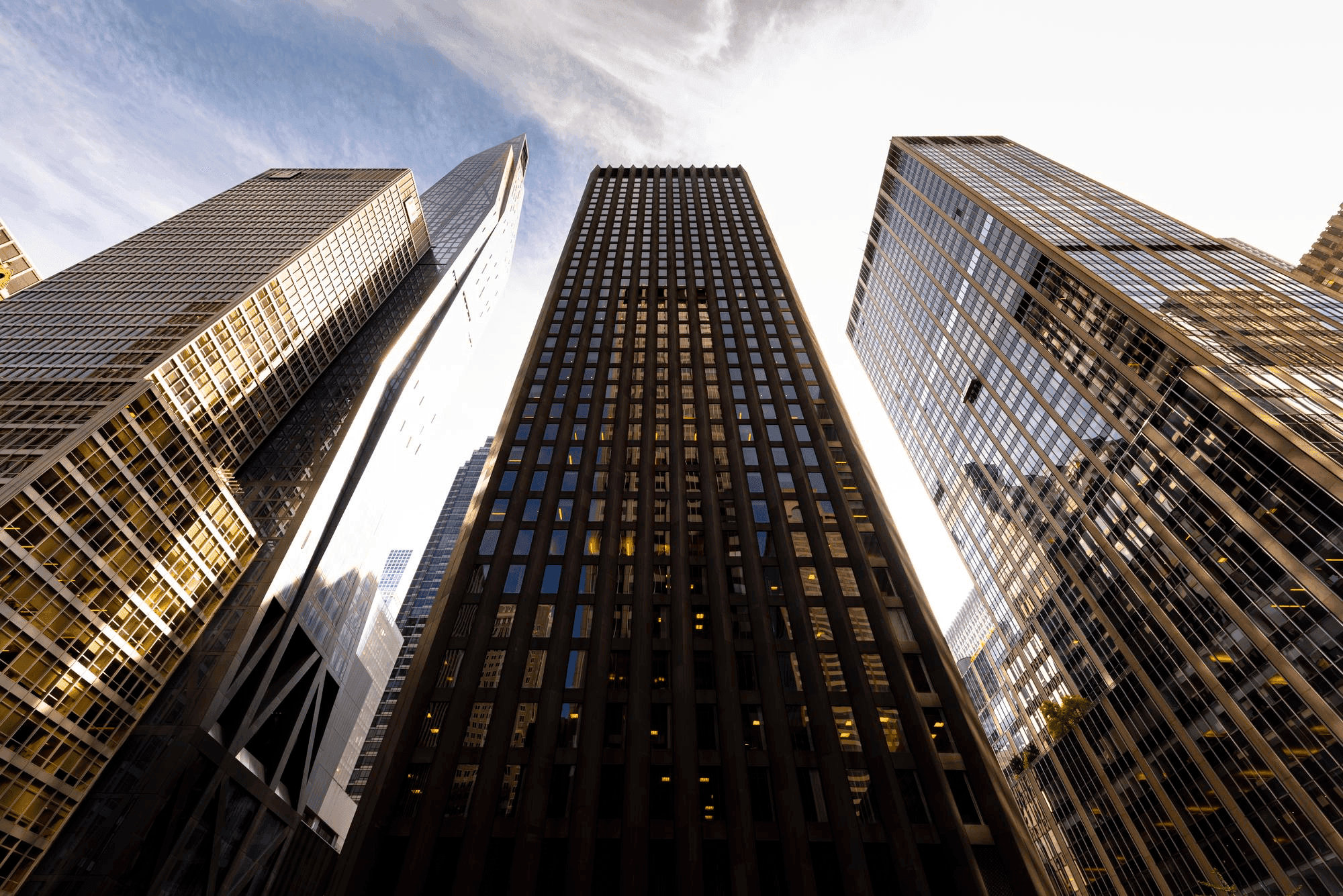 View looking up at skyscrapers representing Wall Street and the financial industry